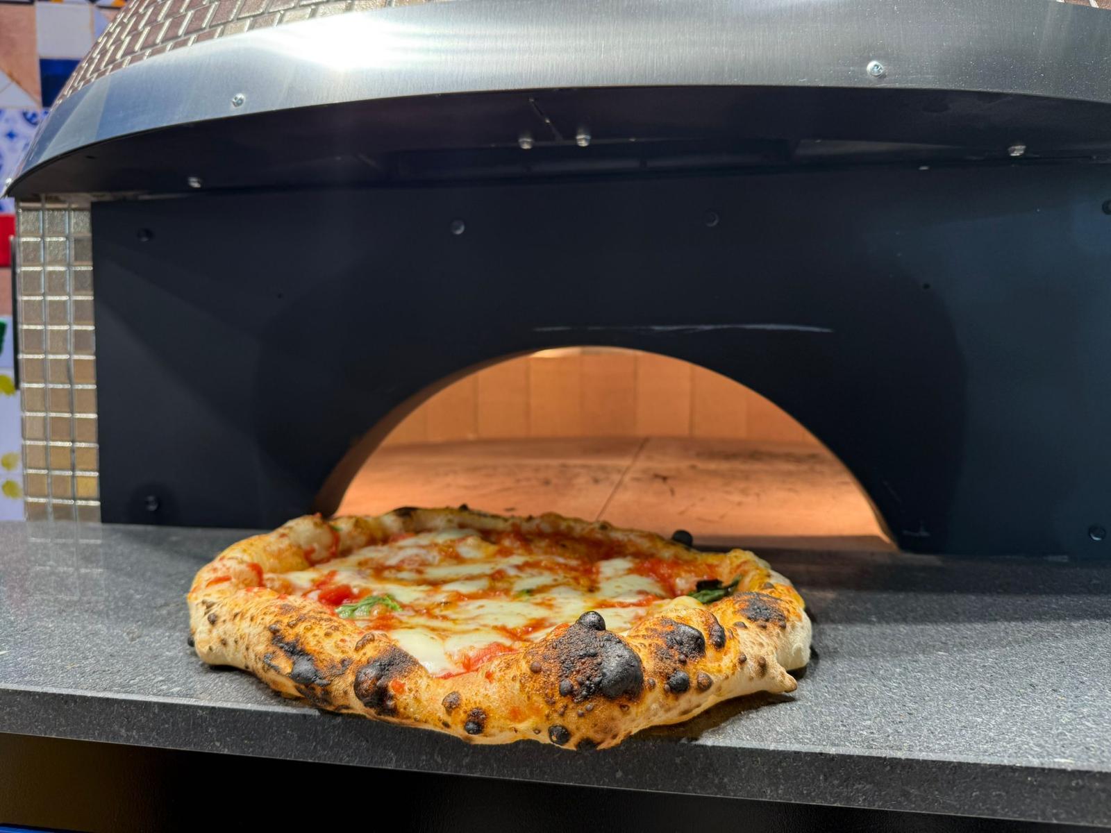 Leopard-spotted Neapolitan pizza baked inside our electric refractory brick oven